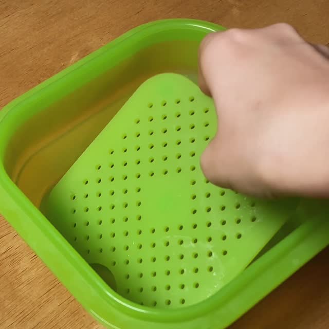 A hand laying the steam tray in the base of a PushLock