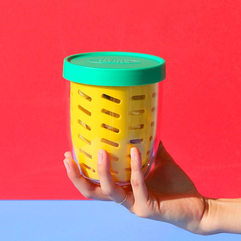 KEEPER POT held in one hand on a red background