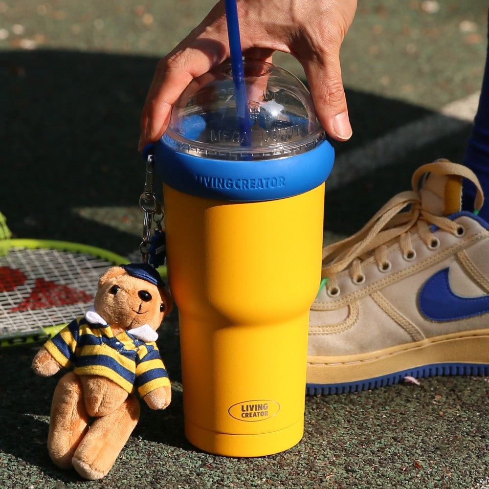 Yellow and blue KEEPER TUM next to sneakers