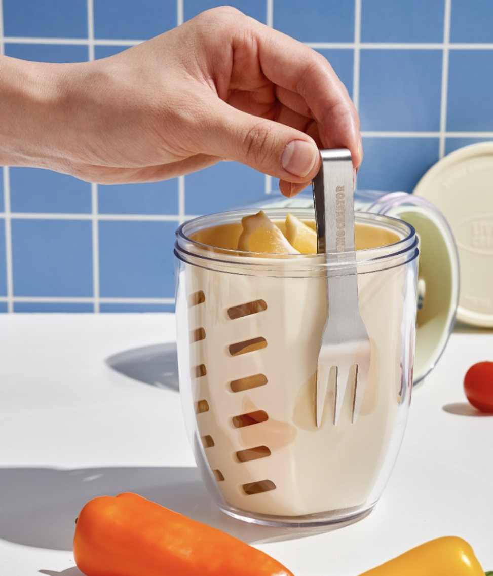 A hand pulling the fork out of a KEEPER POT