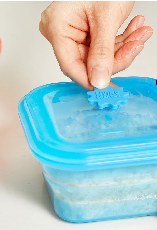 Fingers pinching the steam vent on a PushLock lid